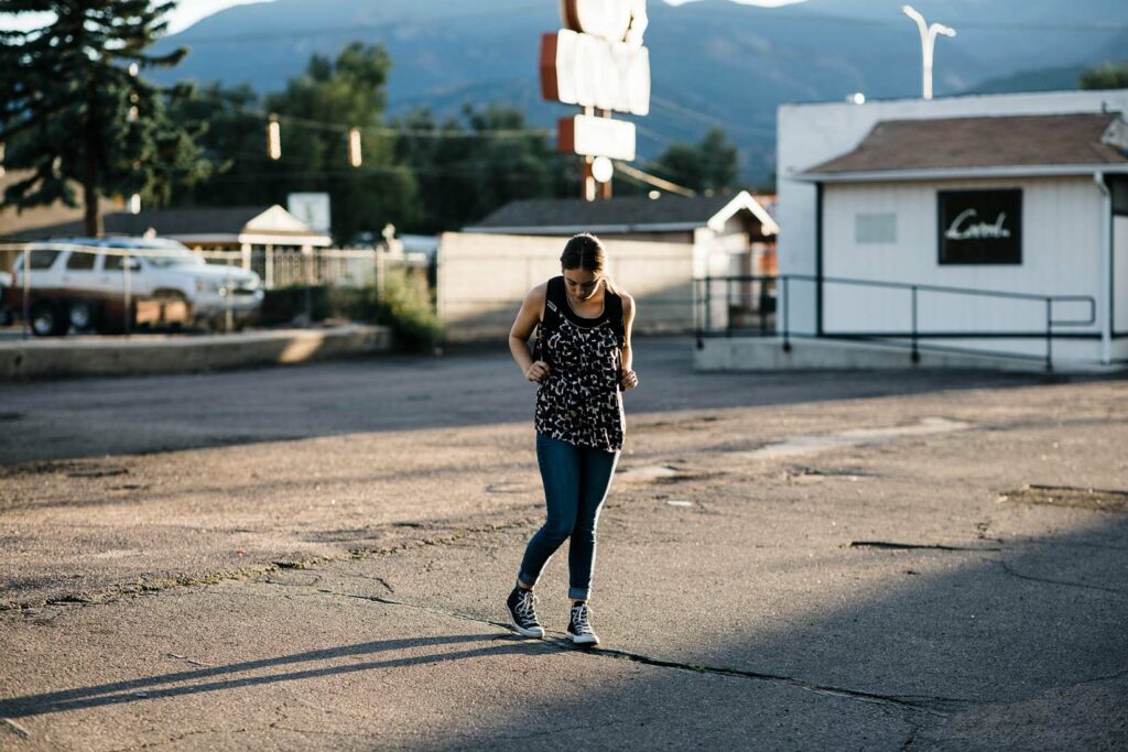 Young teenage American girl stands outside a motel, representing slavery in America today