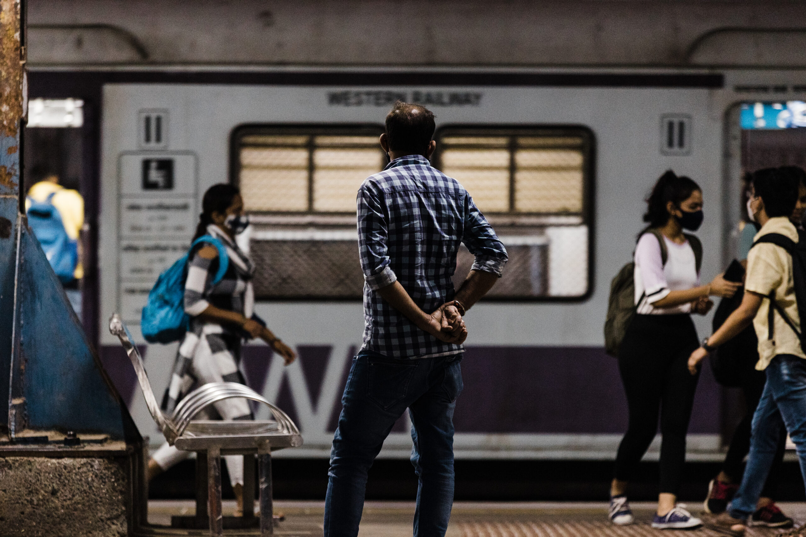 Man stands on a train platform in India, where human trafficking is particularly prevalent