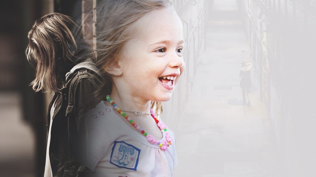 an image of a young girl smiling superimposed onto an image of a young woman looking down grimly, representing the sad connection between foster care and human trafficking