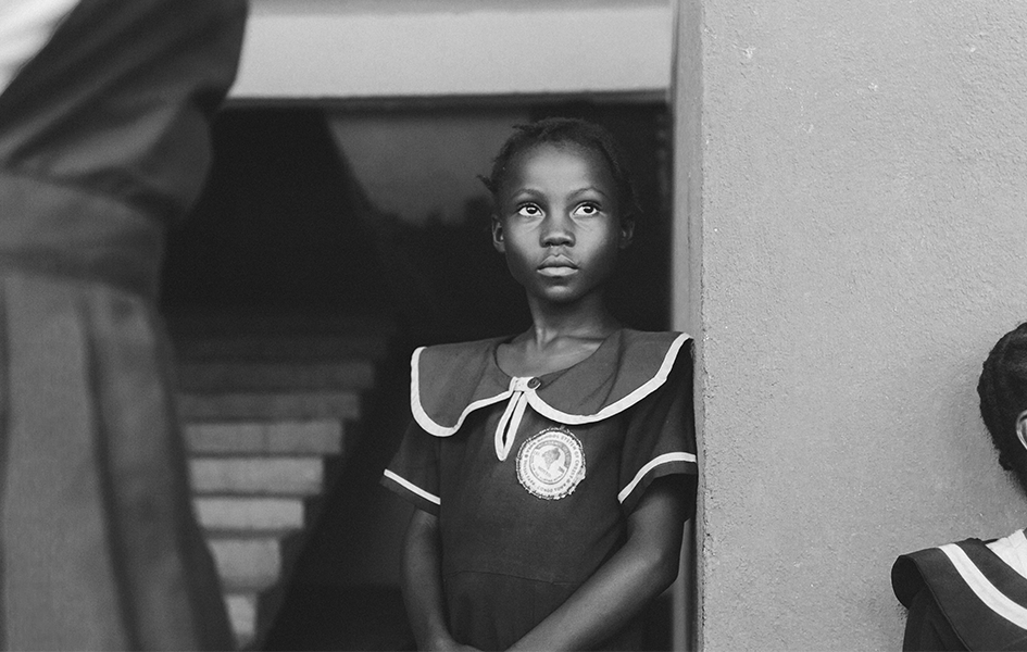 girl leaning against a wall looking solemn, representing the need for aftercare in human trafficking