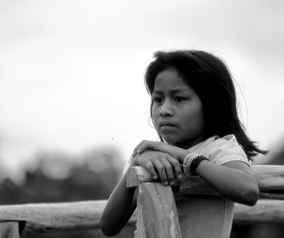 young Southeast Asian girl sitting outside