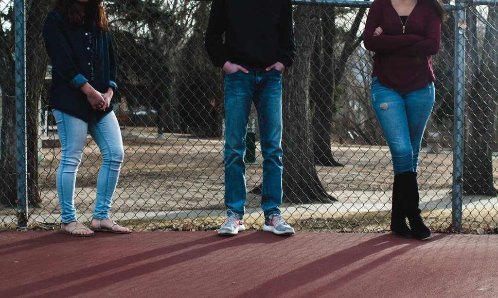three teens hanging out at a park, illustrating the ways to fight human trafficking are things all of us can do