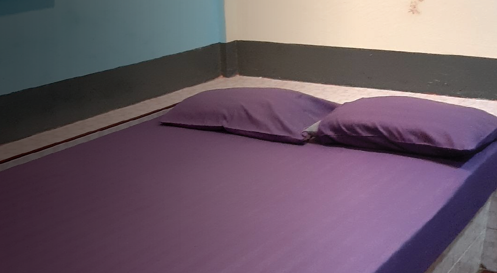 Real image of a bed in a room where a survivor was being trafficked in Thailand.