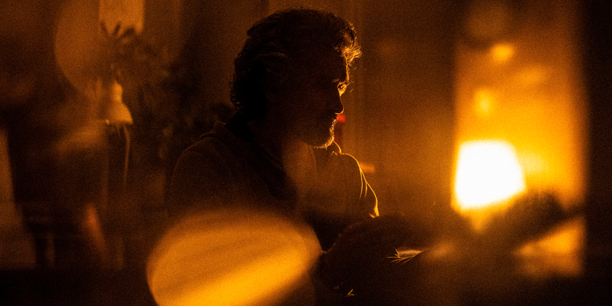 Out of focus silhouette image of a man by a window