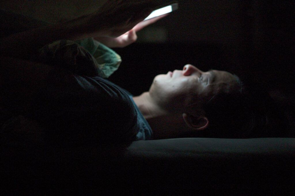 representative porn user looking at his phone in the dark