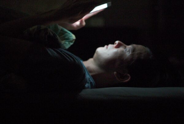 representative porn user looking at his phone in the dark