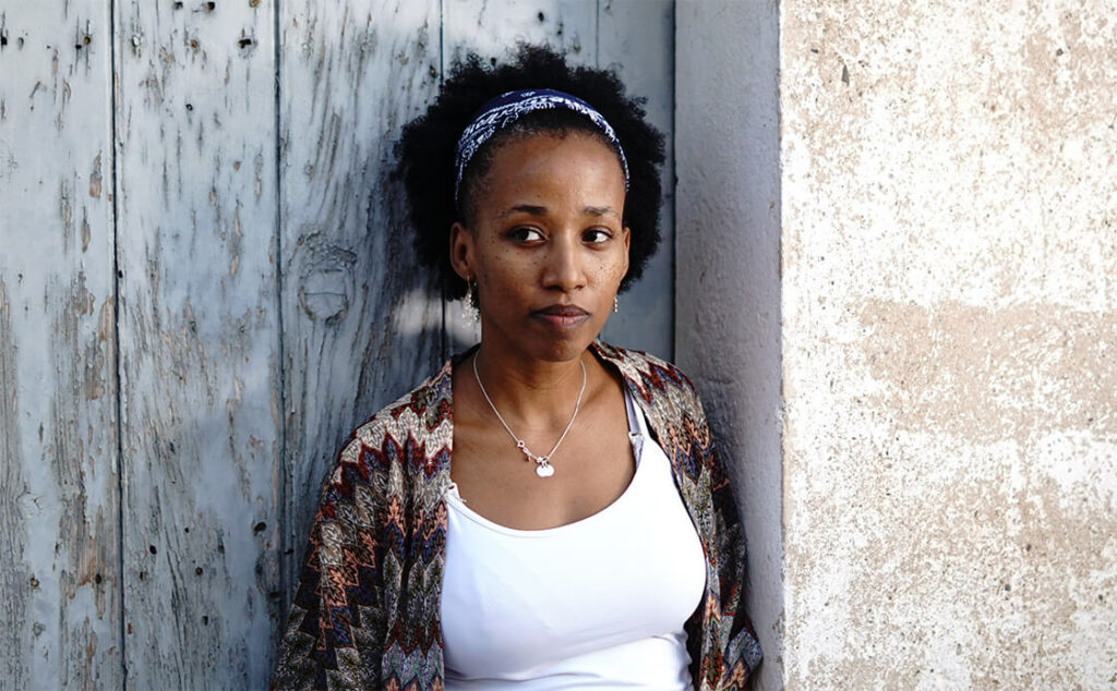 pensive young black woman, representing the connection between race and human trafficking