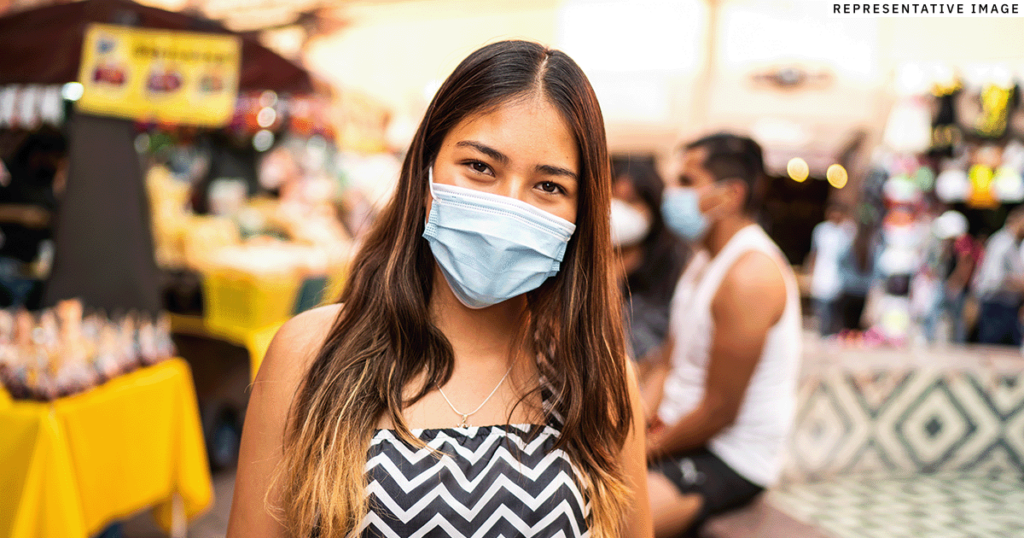 young Latin American woman wearing a mask