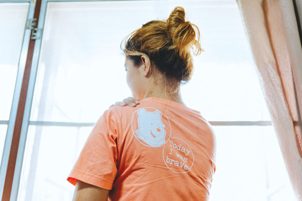 survivor Kratay looking out a sunny window at The Exodus Road's Freedom Home