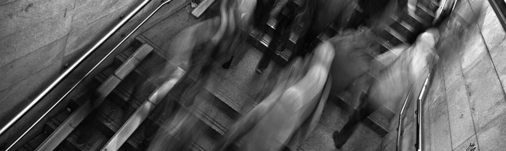 motion blur people walking up and down stairs in black and white