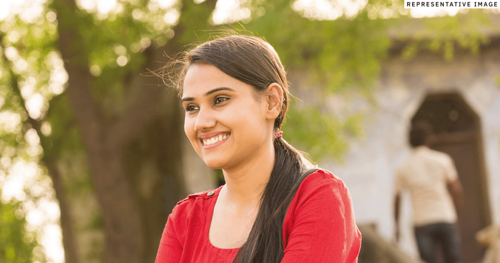 young Indian woman outside smiling