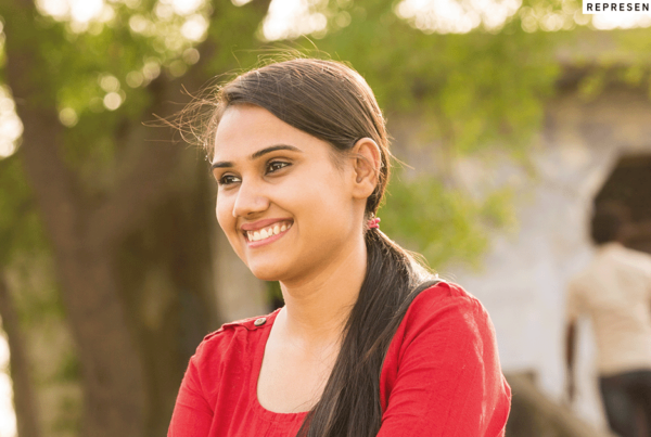young Indian woman outside smiling