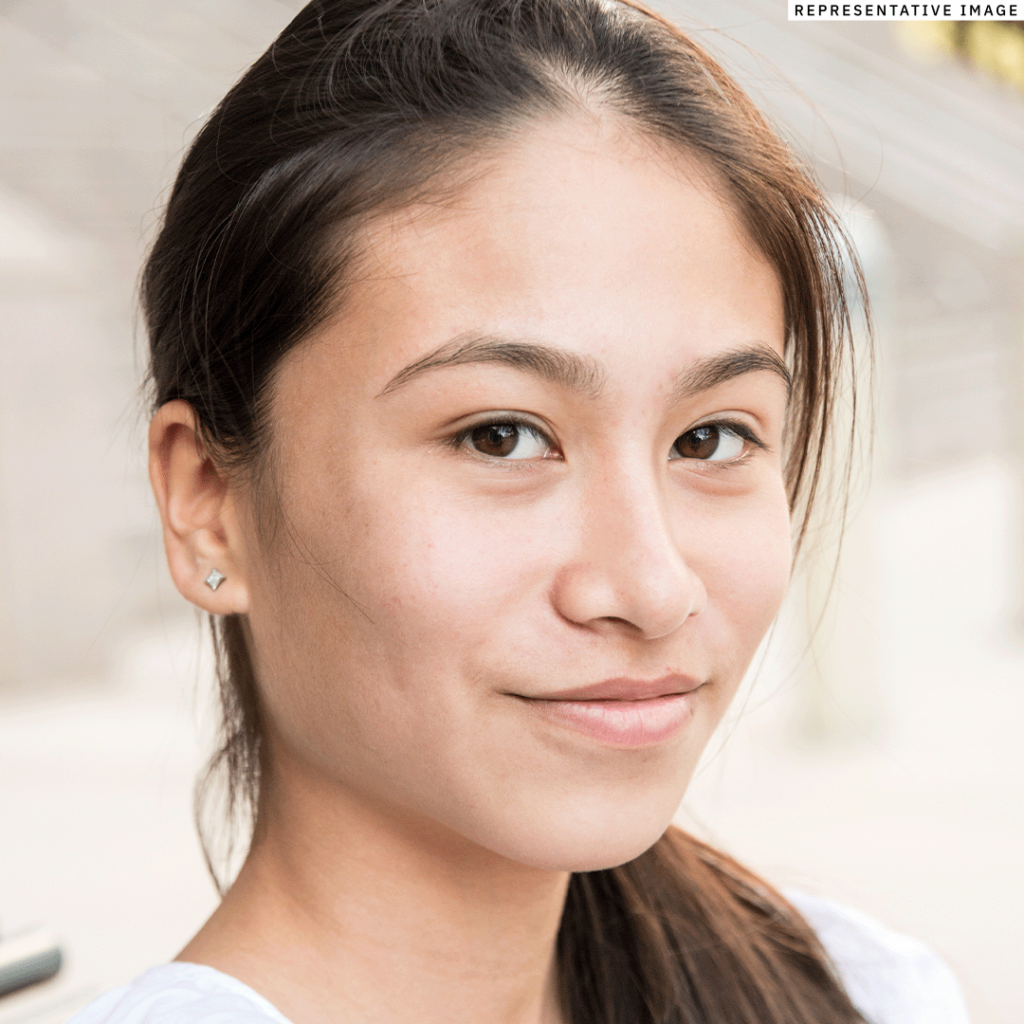 young Filipino woman looking at the view with a soft smile