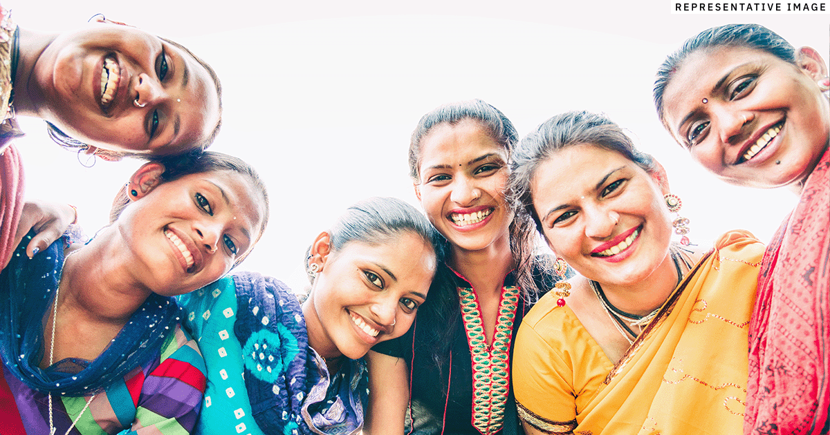 a group of young Indian women smiling