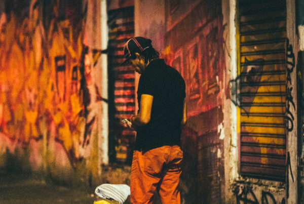 man standing in alley in Latin America at night