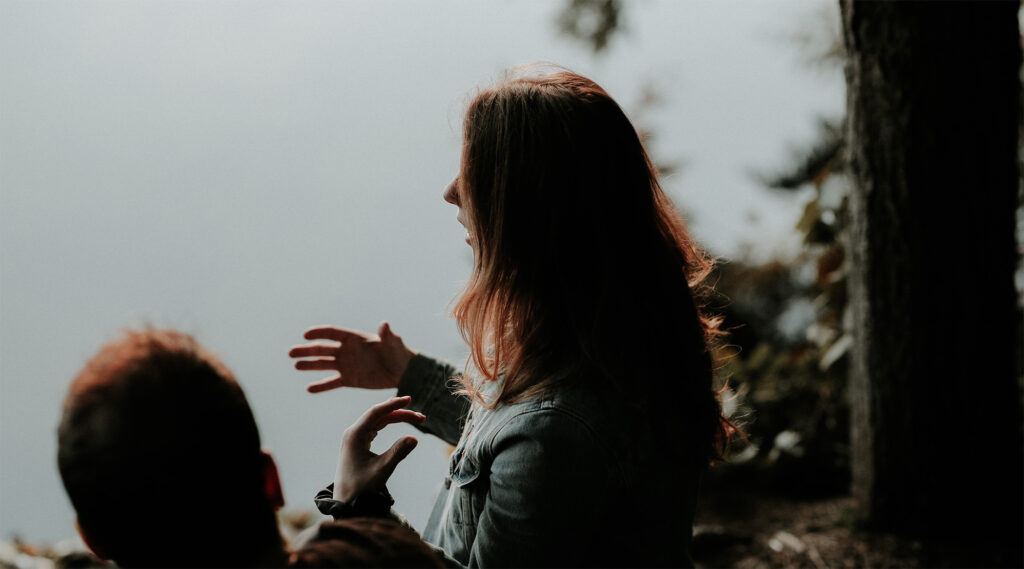 two people sitting together talking