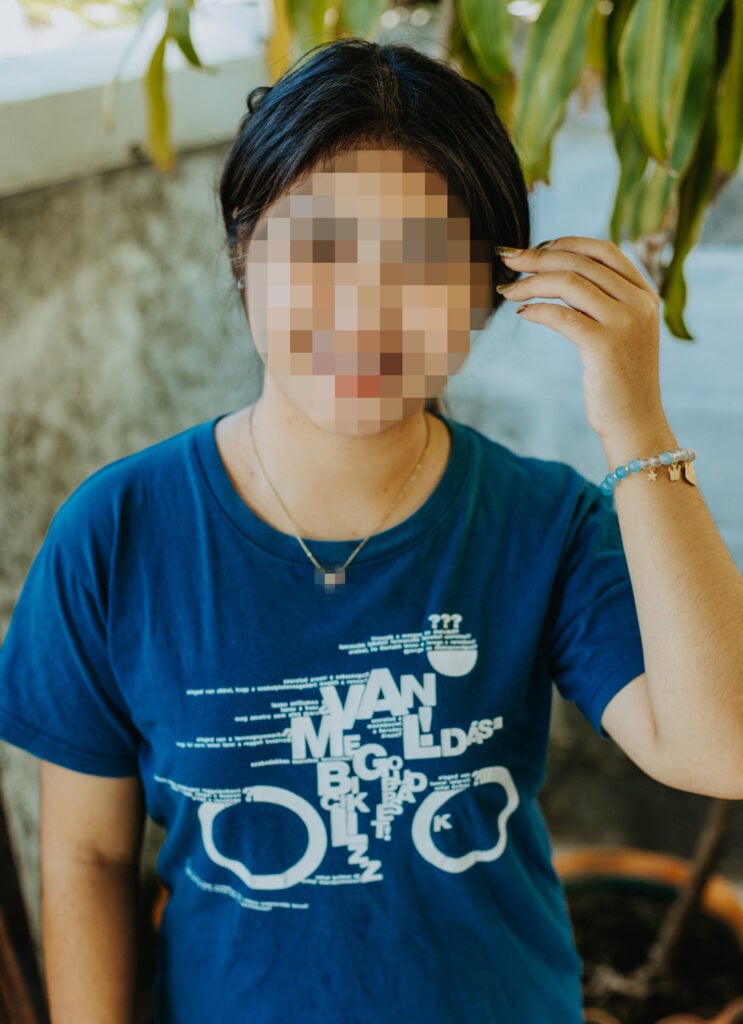 A woman in a blue shirt, Nin at Freedom Home in Thailand.