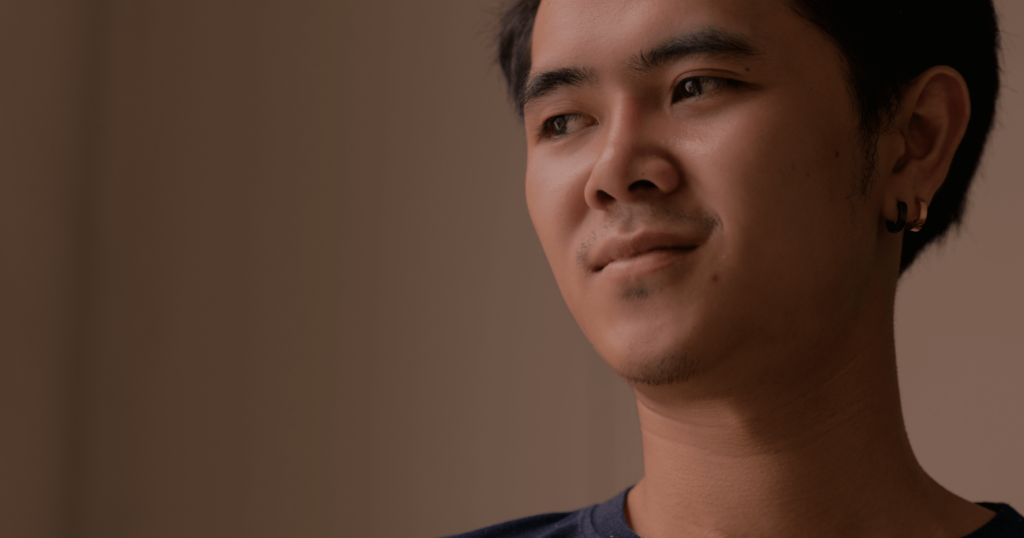 Thai teenage boy looks left