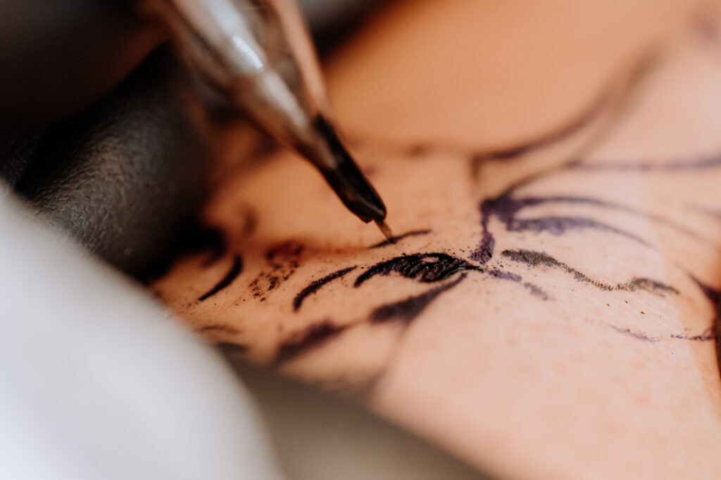 Closeup of a tattoo needle on skin