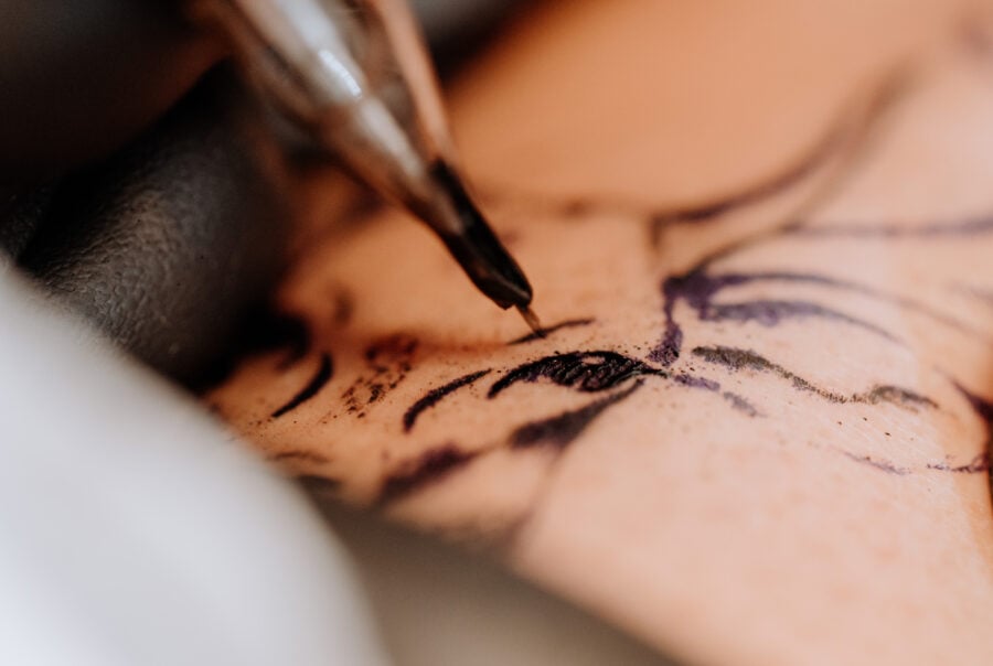 Closeup of a tattoo needle on skin