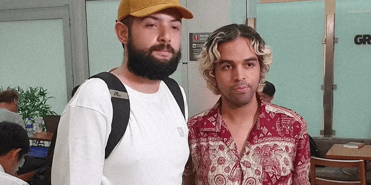 Two Brazilian men stand side-by-side in the Sao Paulo airport, ready to be reunited with their families.