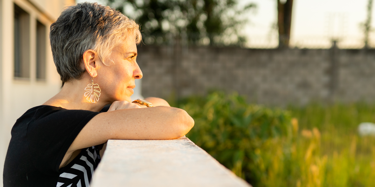 Woman watches the sunset, representative of a human trafficking survivor