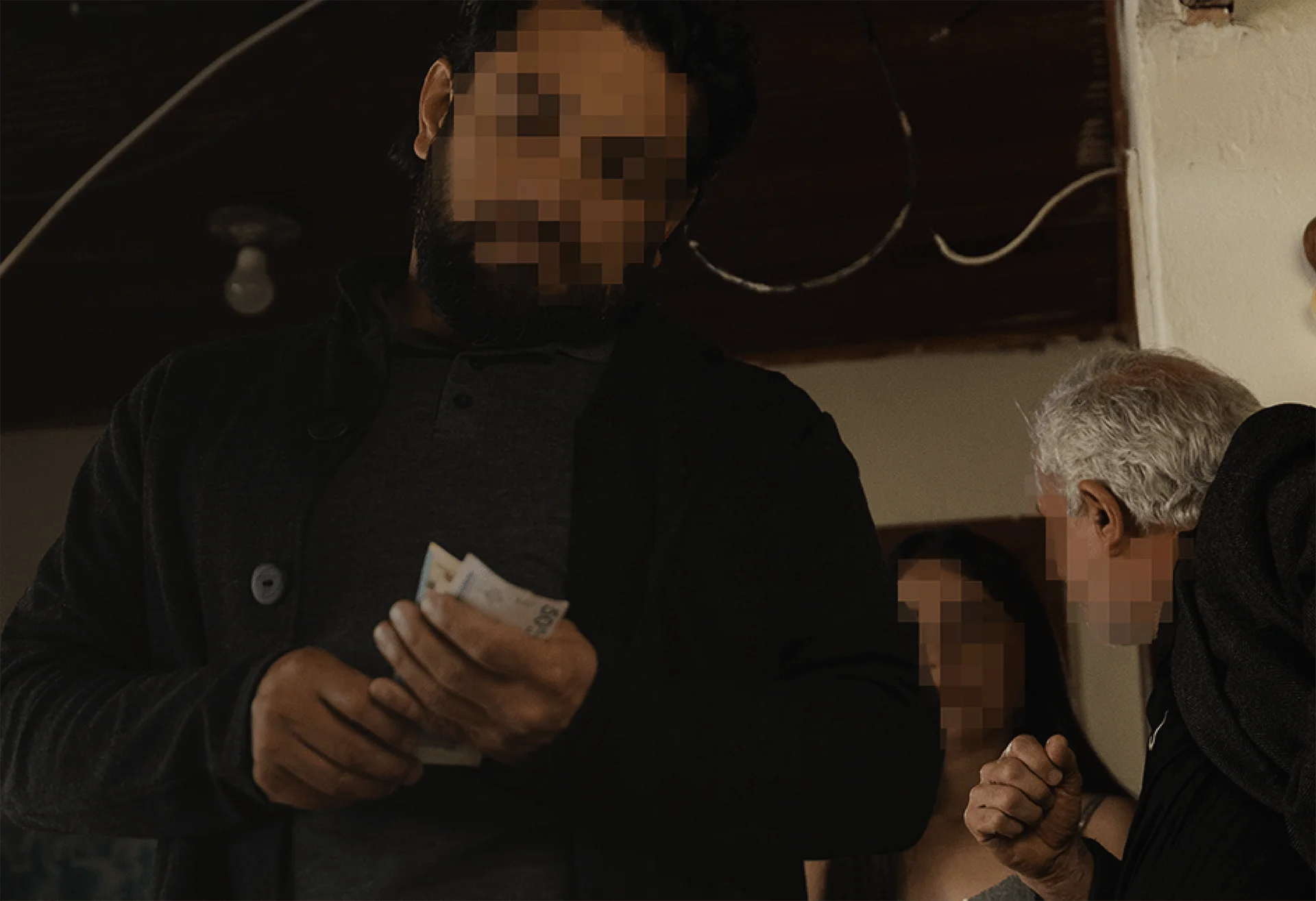 A trafficker counting money, representing the criminal networks The Exodus Road works to dismantle