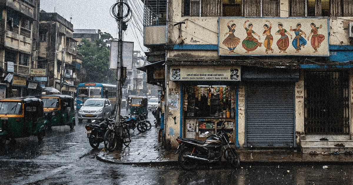 Representative image of a busy Indian street, with a sign on one of the buildings with Indian dancers on it.