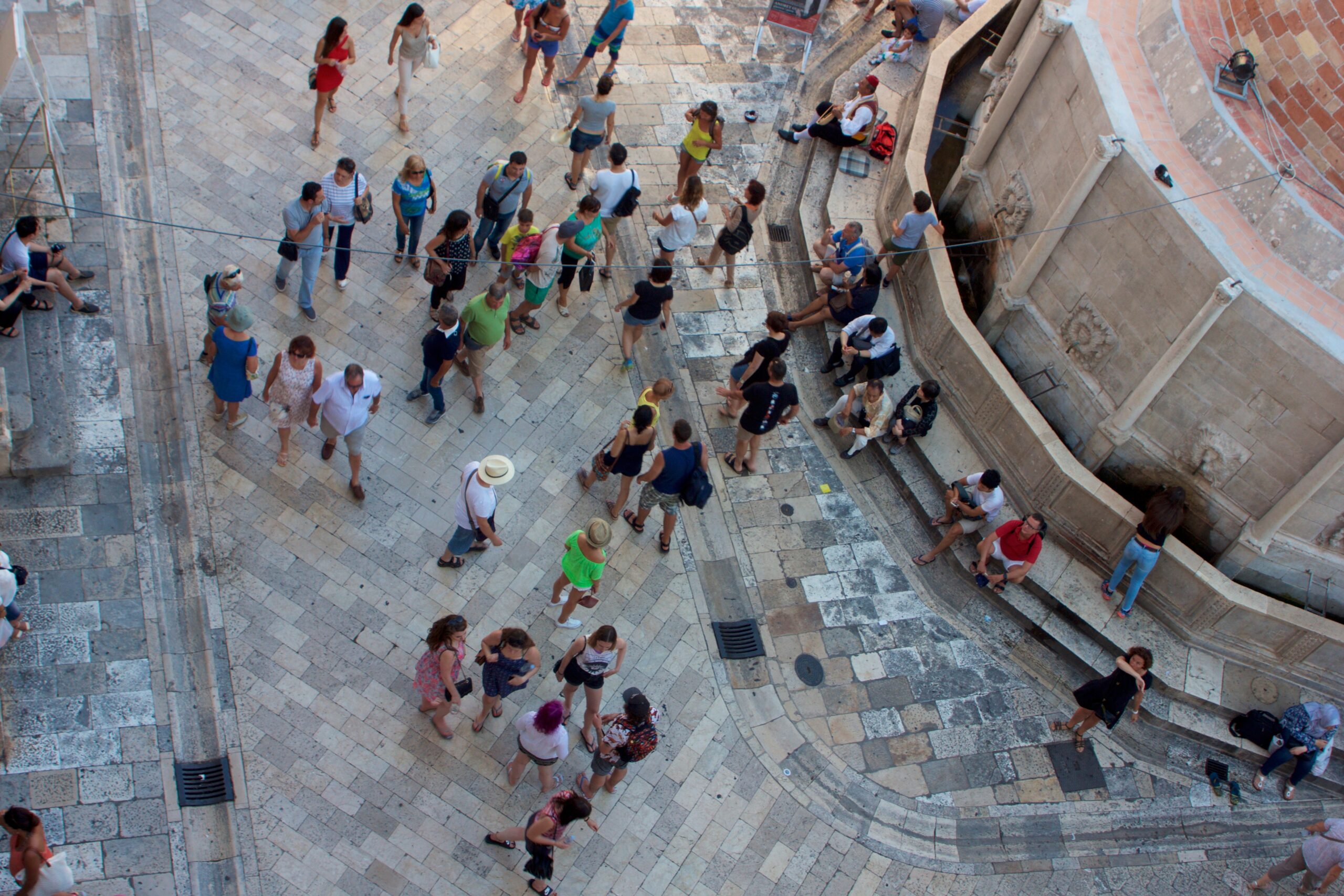 A city square bustling with people in Dubrovnik, Croatia.