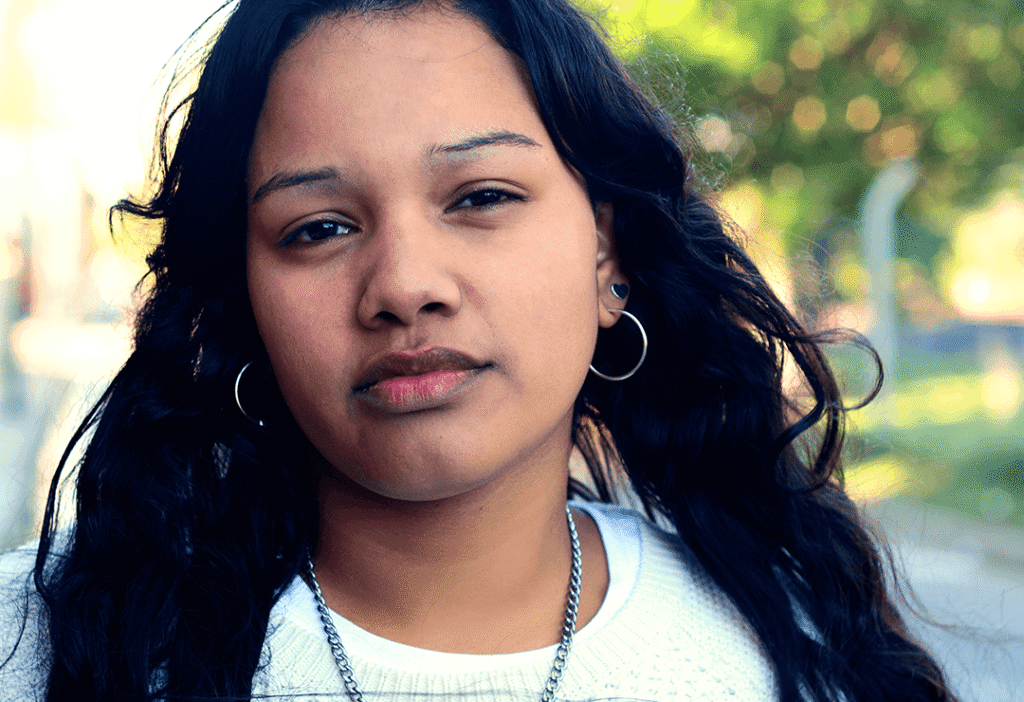 Latin American young woman, looking directly at camera